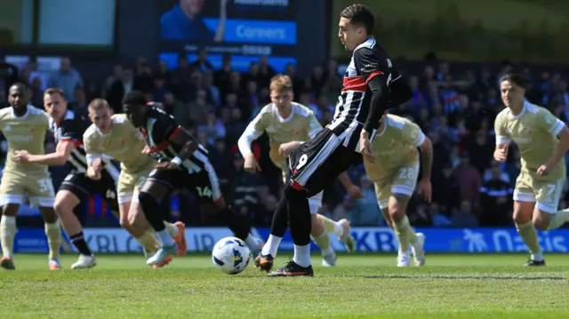 Jaze Kabia of Grimsby Town scores the opening goal against Swindon from a penalty.