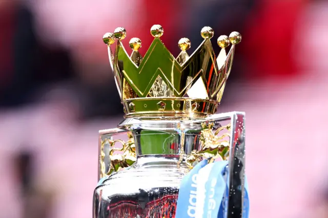 Premier League trophy with blue ribbons