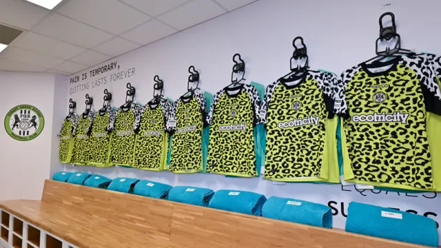 Forest Green shirts on the wall at New Lawn