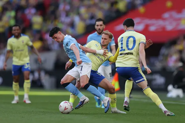 Phil Foden of Manchester City battles for possession with Leo Scienza