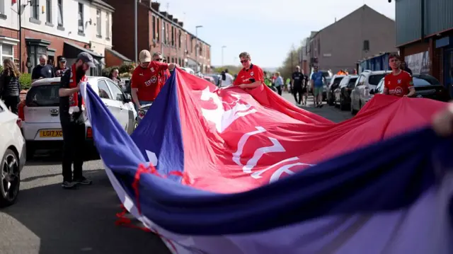 York fans carry a giant banner on their way to Spotland