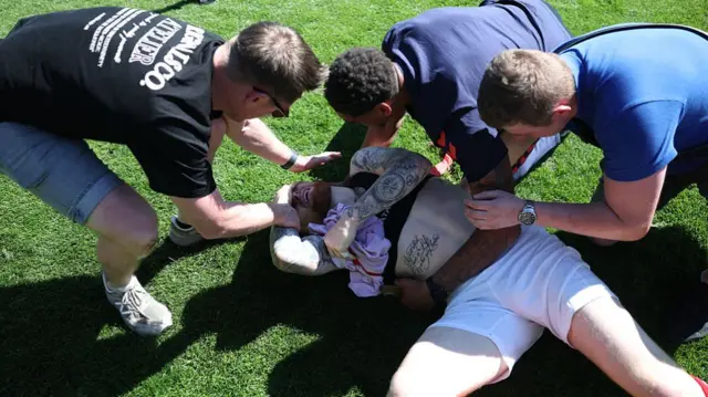 York's Josh Stones is mobbed by fans while he lies on the pitch