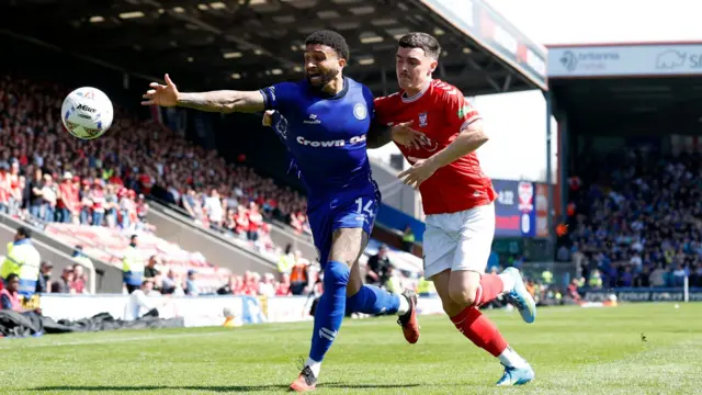 Rochdale's Tobi Adebayo-Rowling (left) and York City's Ben Brookes battle for the ball