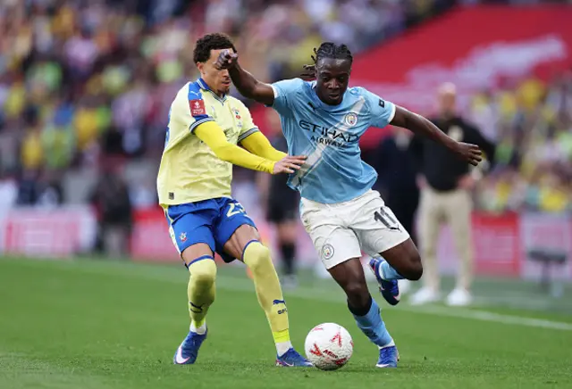 Samuel Edozie of Southampton challenges Jeremy Doku