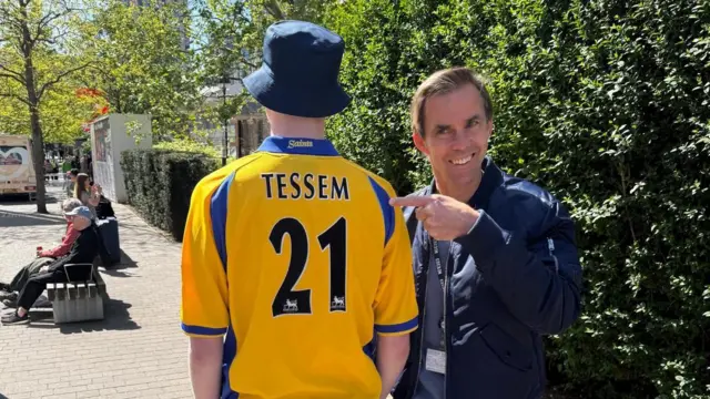 Joe Tessem points to a fan who is wearing a Tessem shirt