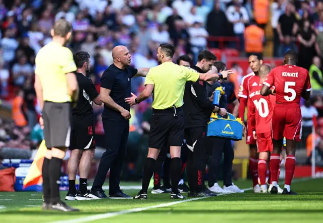 Arne Slot, Manager of Liverpool, speaks with Referee, Andy Madley