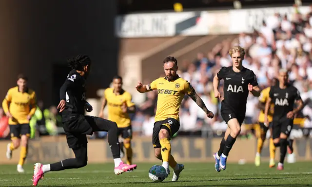Adam Armstrong of Wolverhampton Wanderers controls the ball while under pressure from Djed Spence of Tottenham Hotspur