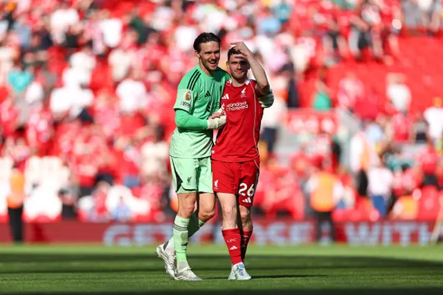 Freddie Woodman of Liverpool celebrates with Andrew Robertson of Liverpool at full time
