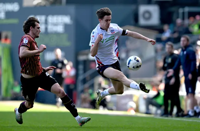 Jayden Wareham of Exeter City feels pressure from Jasper Moon of Burton Albion