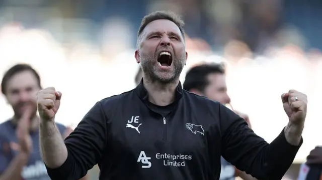 A celebrating Derby boss John Eustace