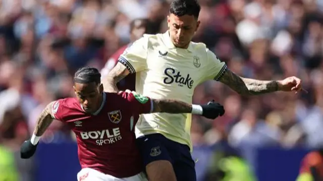 Crysencio Summerville of West Ham United is challenged by Dwight McNeil of Everton