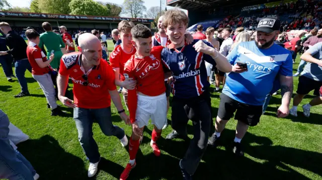 York City fans on the pitch at Rochdale