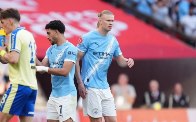 Manchester City substitute Erling Haaland (right) replaces Omar Marmoush