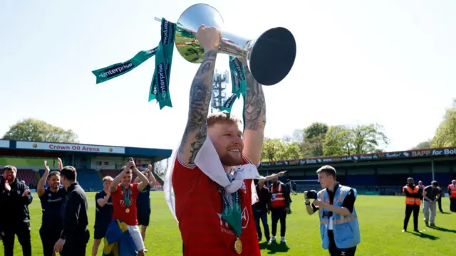 Josh Stones lifts the National League trophy