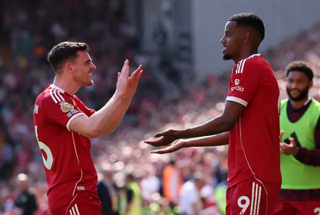 Alexander Isak of Liverpool celebrates scoring his team's first goal with teammate Andrew Robertson