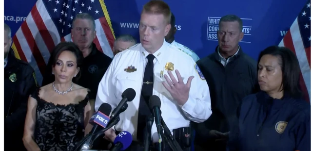 DC police chief Jeff Carroll speaks behind a podium. To the right is DC Mayor Muriel Bowser and to the left is Jeanine Pirro, US Attorney for the District of Columbia