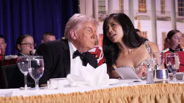 Trump and Jiang sit side by side at a table