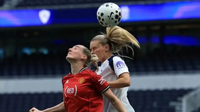 Millie Turner of Manchester United battles for a header with Amanda Nilden of Tottenham Hotspur