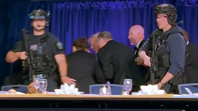 Donald Trump is escorted from the White House Correspondents' Dinner after shots fired