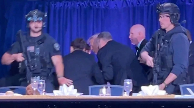 Donald Trump is taken off stage with heavily armed Secret Service personnel in front