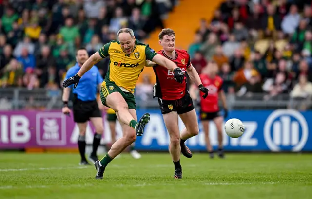 Michael Murphy of Donegal shoots under pressure from Ryan McEvoy of Down
