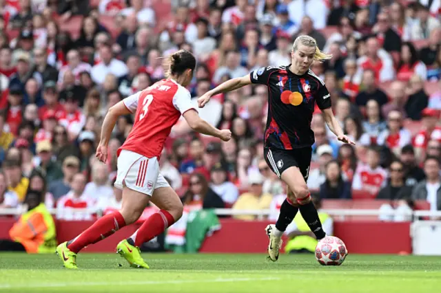 Ada Hegerberg of OL Lyonnes runs with the ball under pressure from Lotte Wubben-Moy of Arsenal