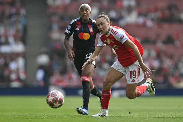 Caitlin Foord is challenged by Lyon's Canadian defender Ashley Lawrence