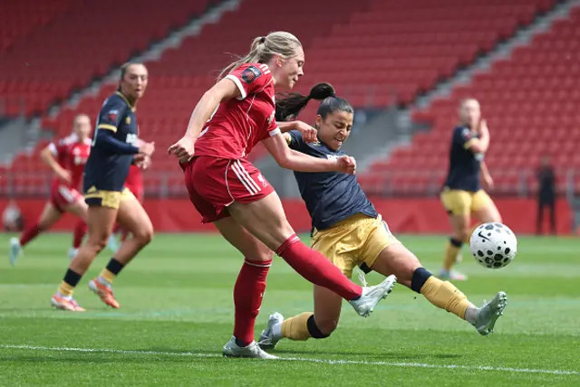 Alice Bergstrom of Liverpool passes the ball under pressure from Ines Belloumou of West Ham United