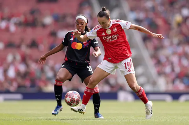 Caitlin Foord of Arsenal is challenged by Ashley Lawrence of OL Lyonnes