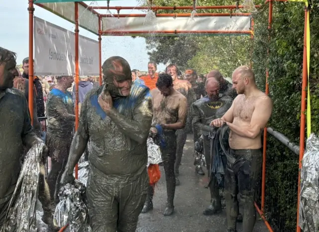People showering mud off