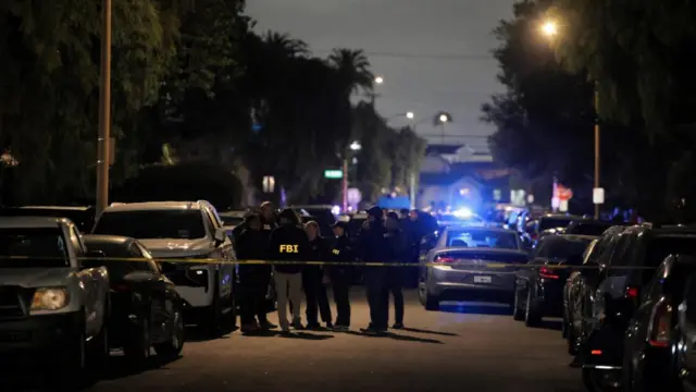 FBI agents and police officers work outside the residence associated with Cole Tomas Allen
