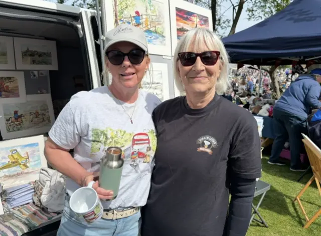 Two women at an art stand