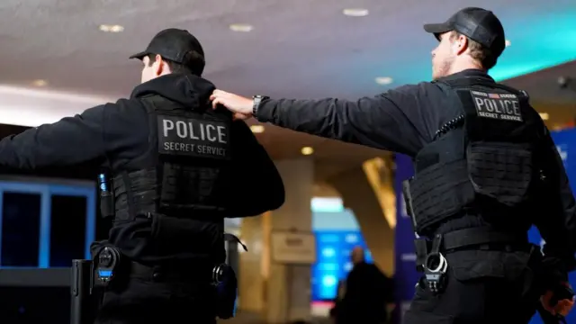 Secret Service police officers react next to the red carpet as a shooter opens fire during the annual White House Correspondents' Association dinne