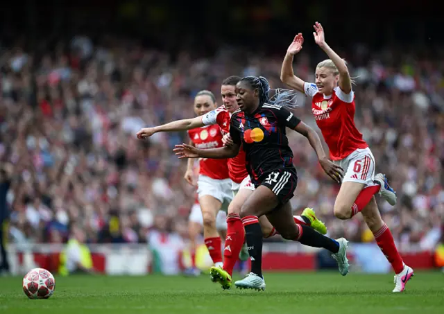 Kadidiatou Diani of OL Lyonnes runs with the ball under pressure from Lotte Wubben-Moy and Leah Williamson of Arsenal