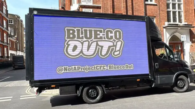 A lorry driving around with Not A Project CFC digital board message reading BlueCo out