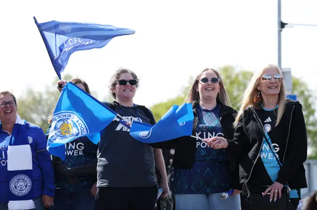 Leicester City women fans wave flags outside Copperjax Stadium