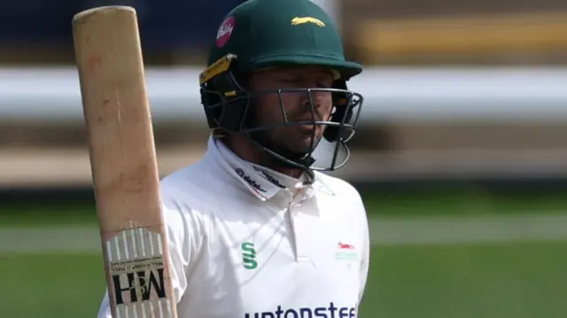 Ian Holland celebrates scoring fifty