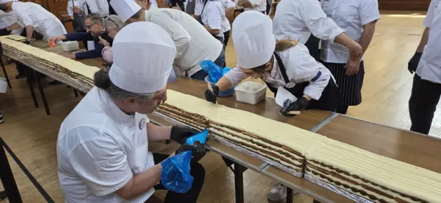 A chef pipes the dessert
