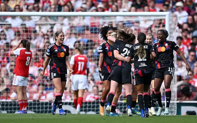 Jule Brand of OL Lyonnes celebrates scoring her team's first goal with teammates