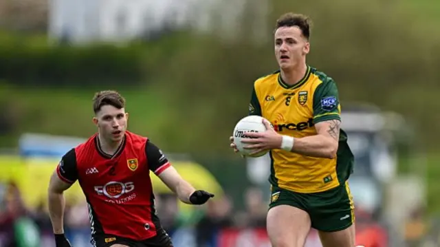 Jason McGee of Donegal in action against Down's Peter Fegan
