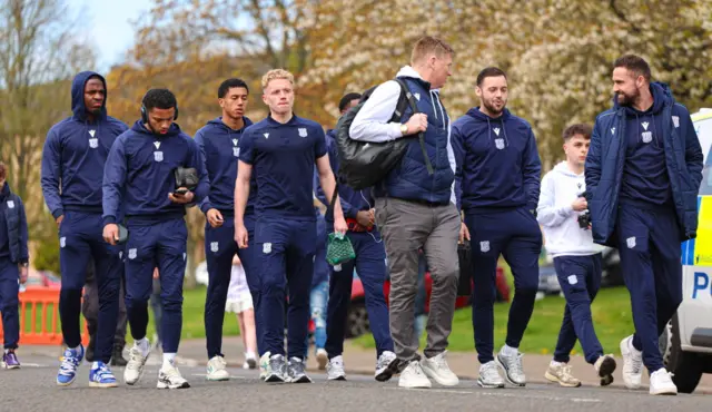 Joe Westley (centre left) and the Dundee squad walk to the stadium
