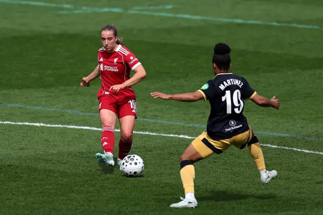 Kirsty MacLean of Liverpool passes the ball while under pressure from Shekiera Martinez