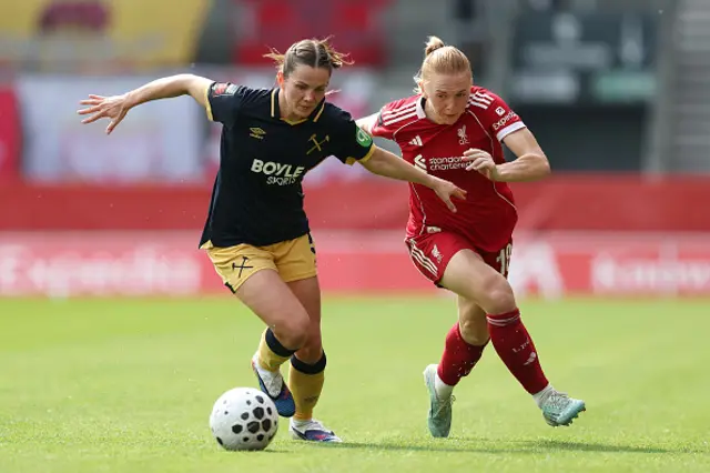 Tuva Hansen of West Ham United is challenged by Ceri Holland of Liverpool