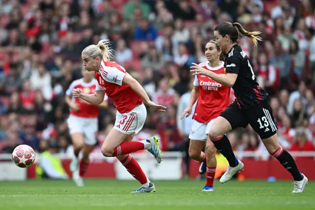 Alessia Russo of Arsenal is challenged by Damaris Egurrola
