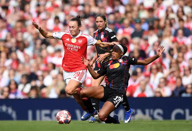 Caitlin Foord of Arsenal is challenged by Ashley Lawrence of OL Lyonnes