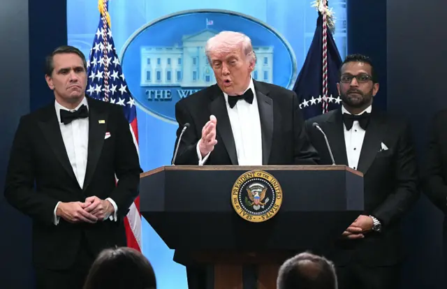 President Donald Trump speaks flanked by FBI Director Kash Patel and acting Attorney General Todd Blanche