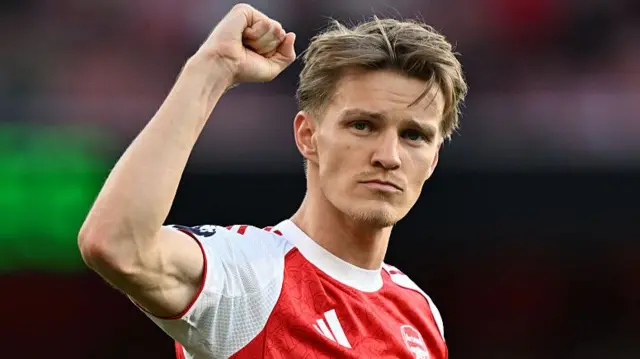 Martin Odegaard signals to Arsenal fans with a clenched fist