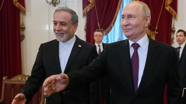 Russian President Vladimir Putin (R) and Iranian Foreign Minister Abbas Araghchi walk to attend their talks at the Boris Yeltsin Presidential Library in St. Petersburg, Russia, 27 April 2026.