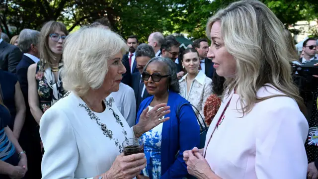 Queen Camilla greets CEO of the National Center for Missing & Exploited Children Michelle DeLaune as they attend a garden party at the British Embassy on day one of the Royal's State Visit to the United States of America, in Washington, DC., U.S., April 27, 2026.