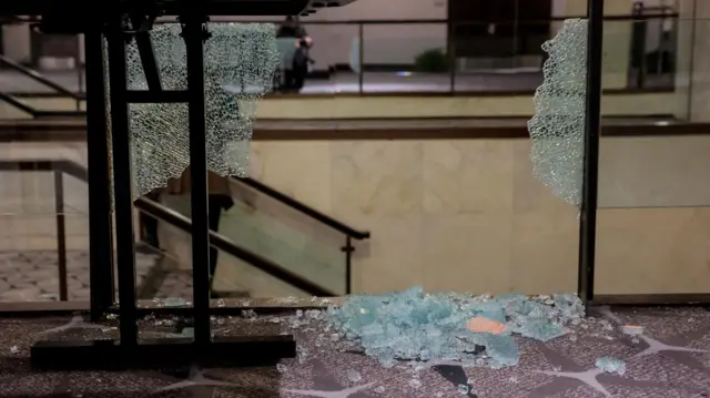 Broken glass seen in the foyer of the hotel, the morning after the shooting took place